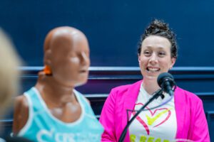 Cameron Motsenbocker from Hands Over Hearts with CPR Taylor (L) her instructional mannequin who has breasts because according to Cameron women are more likely to die from cardiac arrest when CPR could have saved them because people are afraid to touch women's breasts